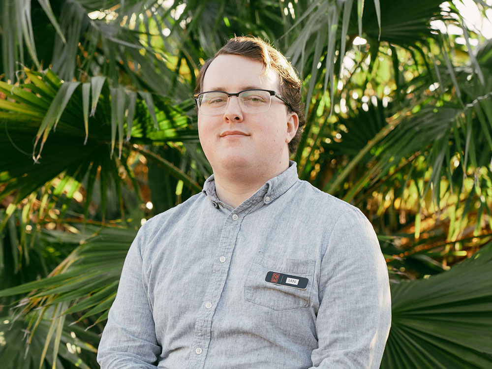 ian-robinson-headshot-25 Ian headshot in front of palm leaves